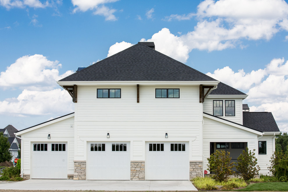 Exemple d'une grande façade de maison blanche chic en panneau de béton fibré à un étage avec un toit à quatre pans et un toit en shingle.