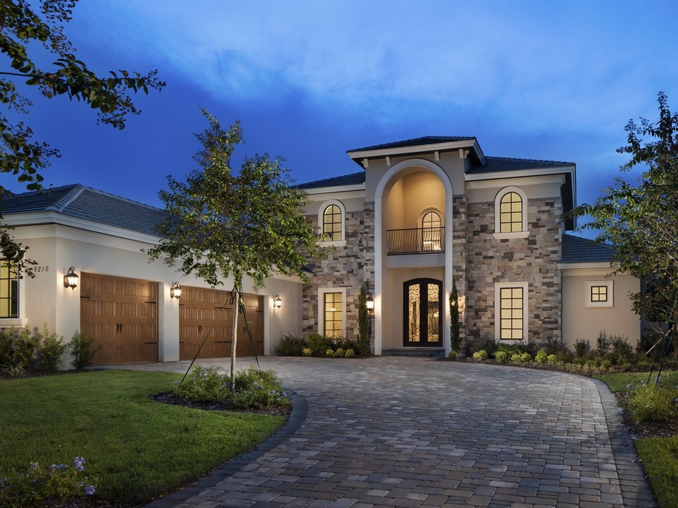 Large transitional beige two-story mixed siding exterior home idea in Orlando with a hip roof