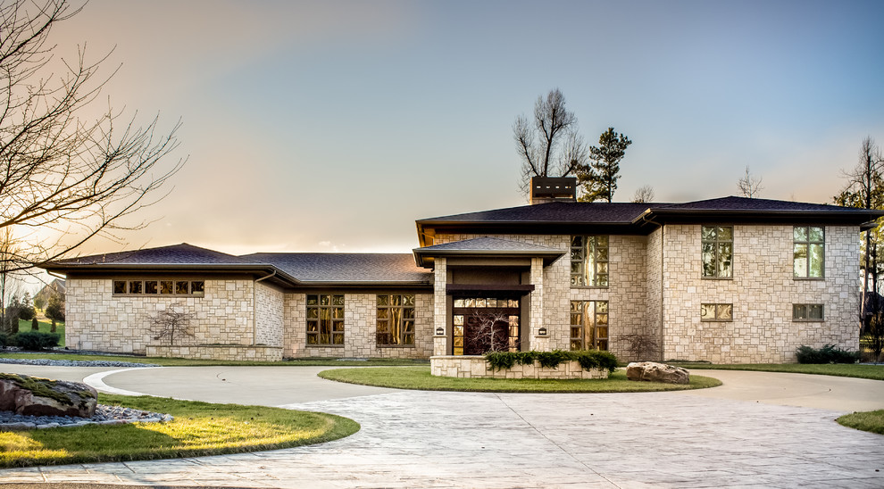 Photo of an expansive and beige contemporary two floor detached house in Nashville with stone cladding and a shingle roof.