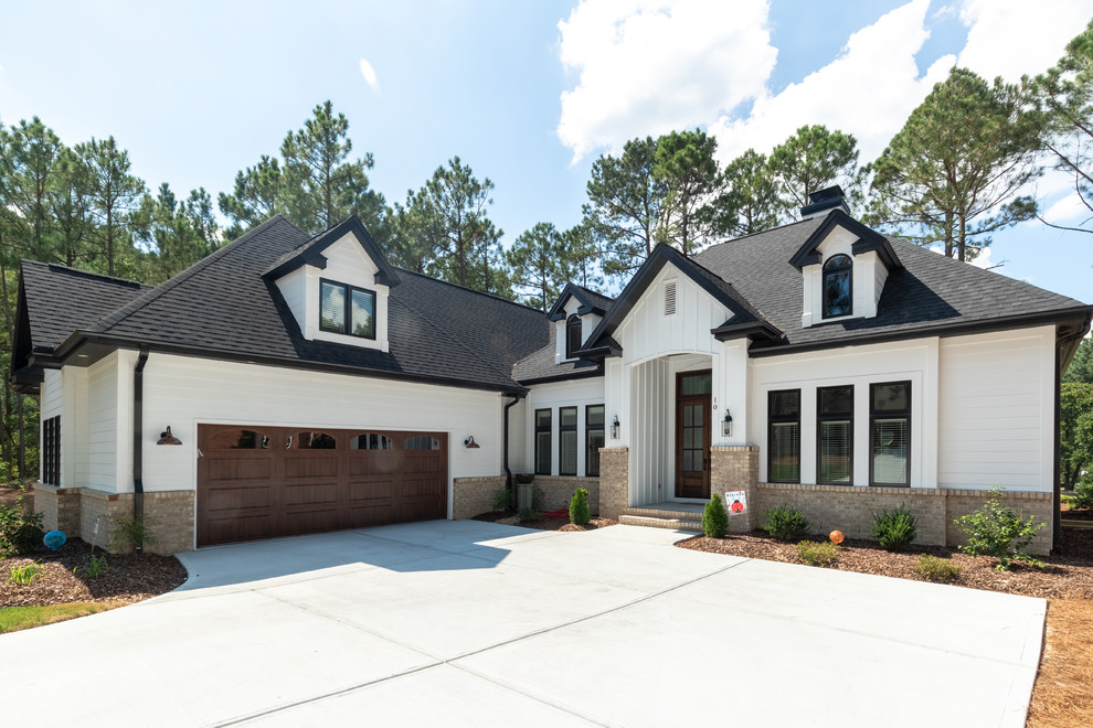 Inspiration for a mid-sized transitional white one-story wood house exterior remodel in Raleigh with a hip roof and a shingle roof