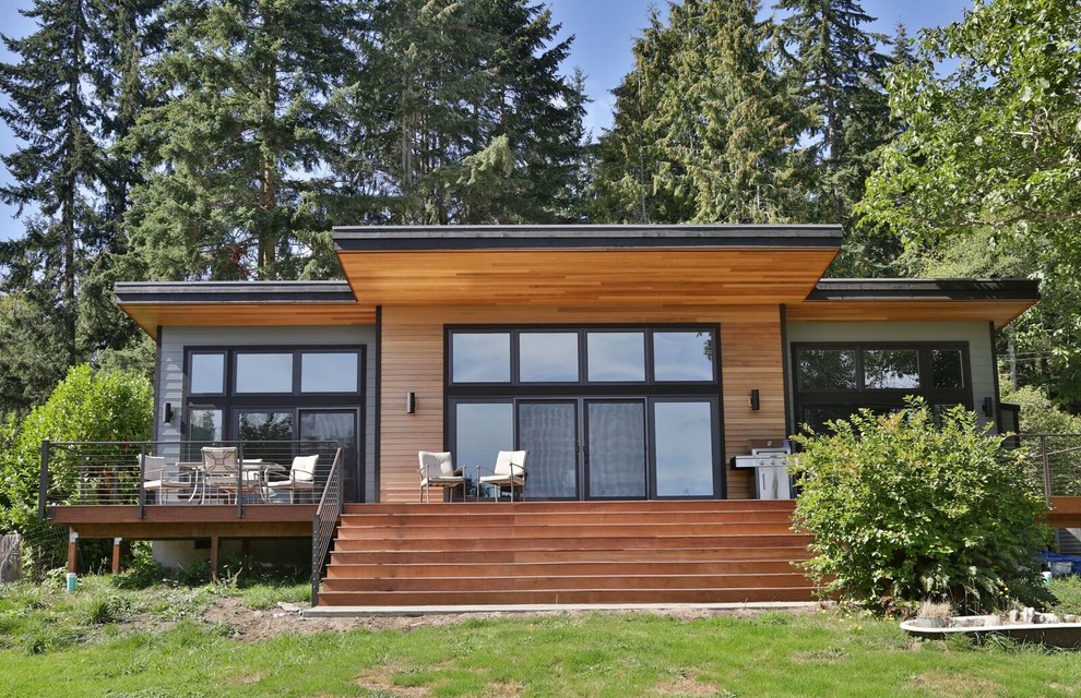 Design ideas for a medium sized modern bungalow house exterior in Seattle with mixed cladding and a flat roof.