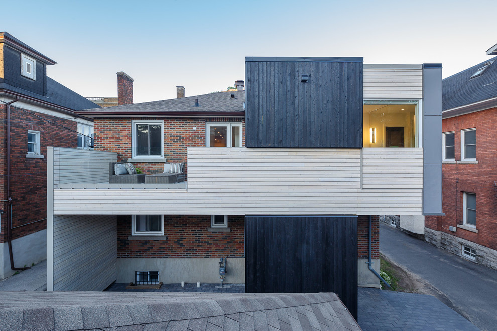 Inspiration for a medium sized and multi-coloured contemporary two floor detached house in Ottawa with mixed cladding, a half-hip roof and a shingle roof.