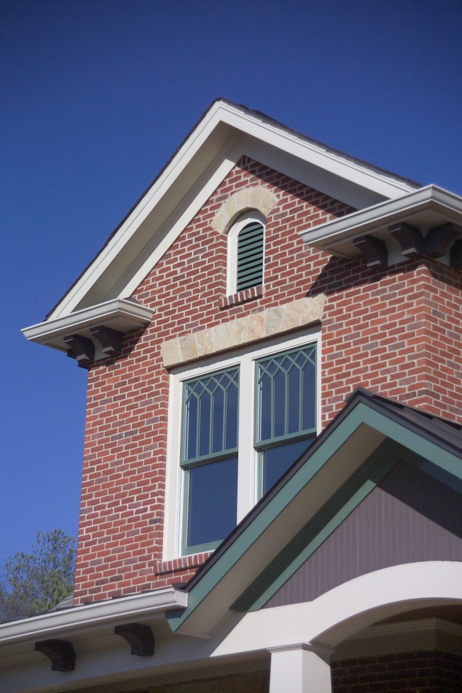 Example of a mid-sized classic three-story brick house exterior design in Atlanta with a hip roof and a shingle roof