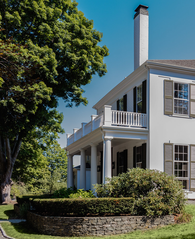Example of a transitional white mixed siding house exterior design with a shingle roof