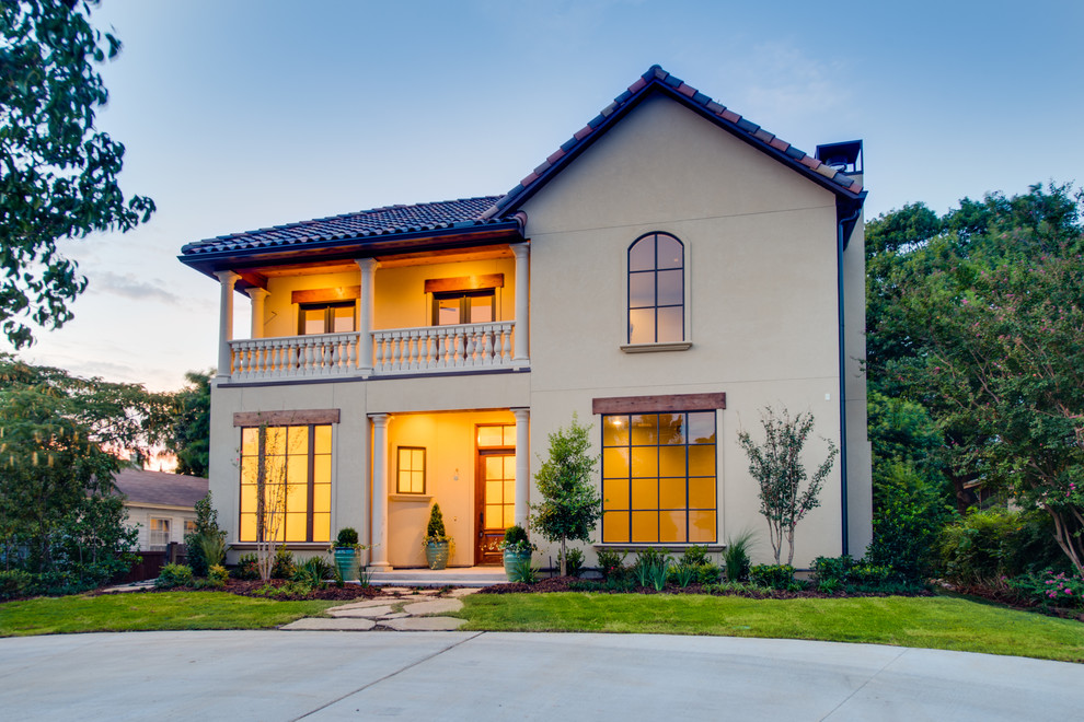 Example of a large tuscan beige two-story exterior home design in Dallas
