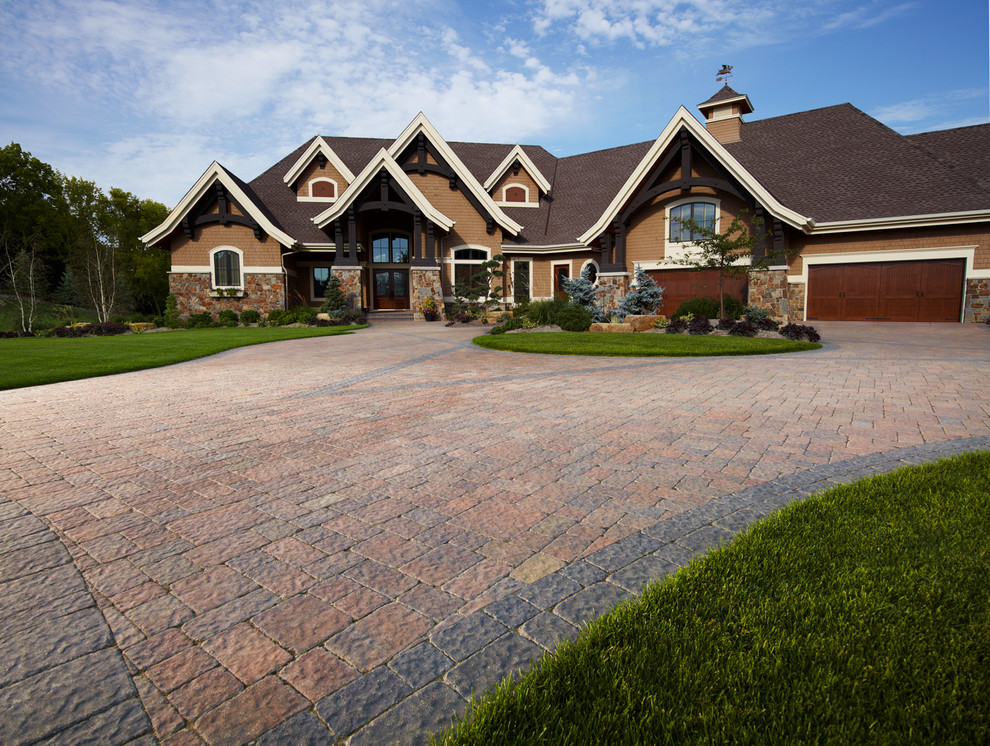 Design ideas for a large and brown traditional house exterior in Minneapolis with stone cladding.