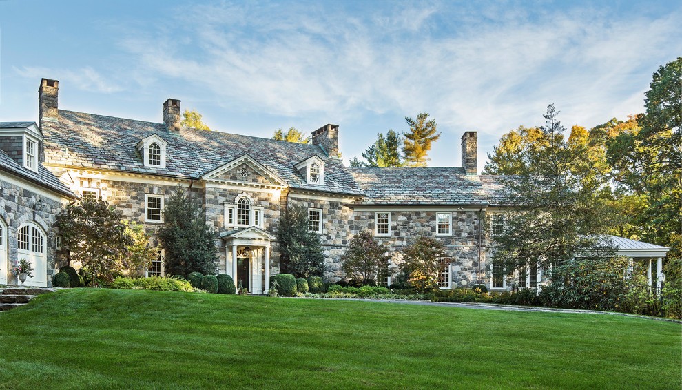 Photo of an expansive traditional detached house in New York with three floors, stone cladding and a shingle roof.