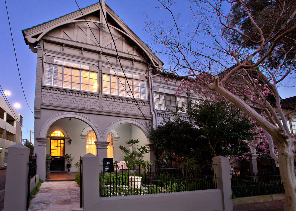 Example of a small classic gray three-story concrete gable roof design in Sydney