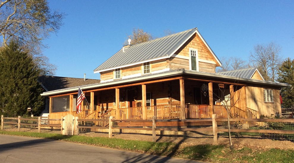 Inspiration for a large and brown rural two floor house exterior in Indianapolis with wood cladding and a hip roof.