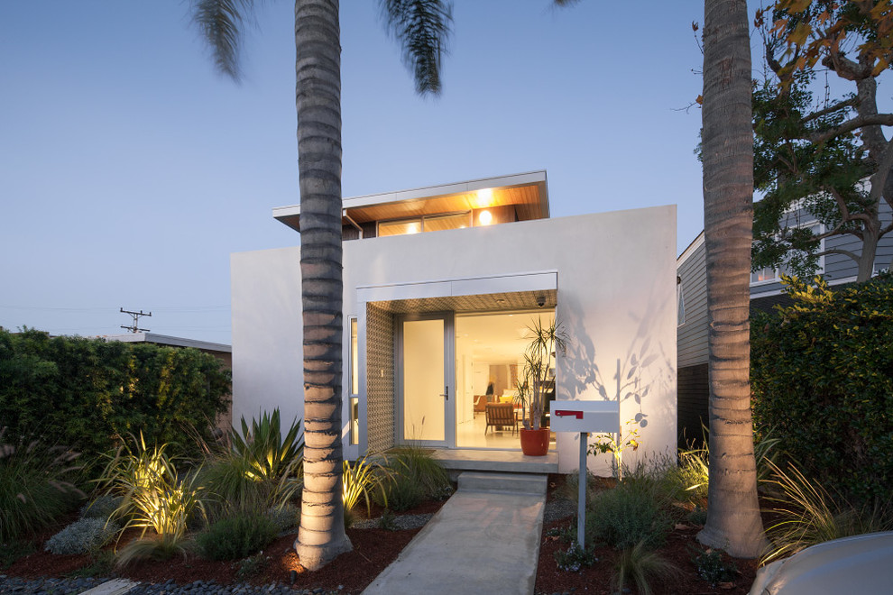 Photo of a white modern two floor house exterior in Los Angeles with a flat roof.