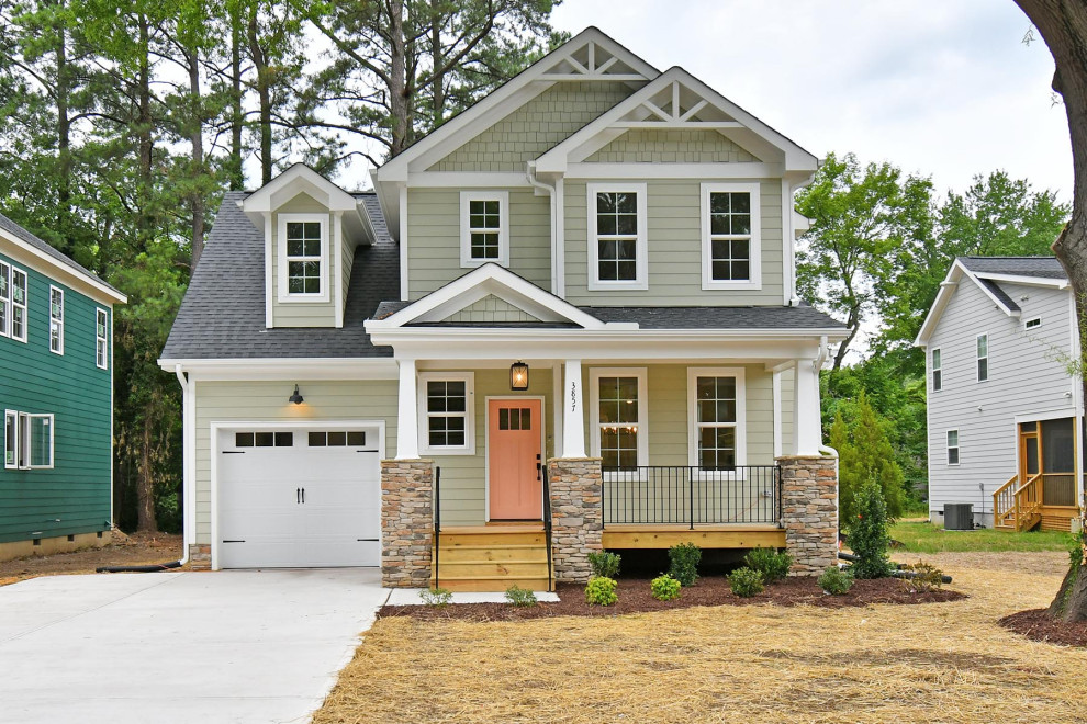 Mid-sized elegant green two-story concrete fiberboard exterior home photo in Raleigh with a shingle roof
