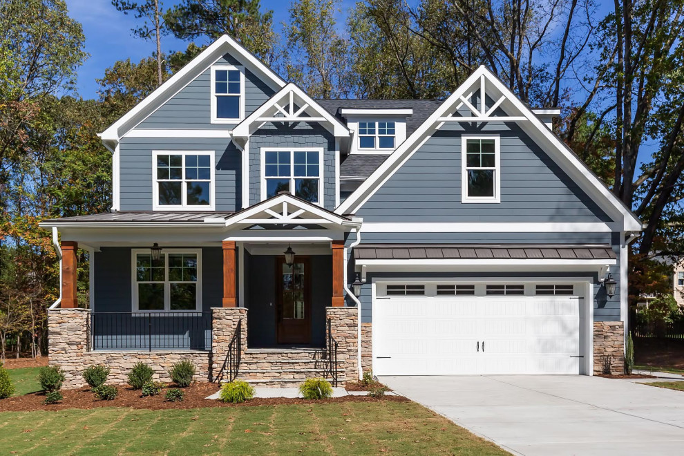 Example of a large classic gray two-story concrete fiberboard exterior home design in Raleigh with a shingle roof