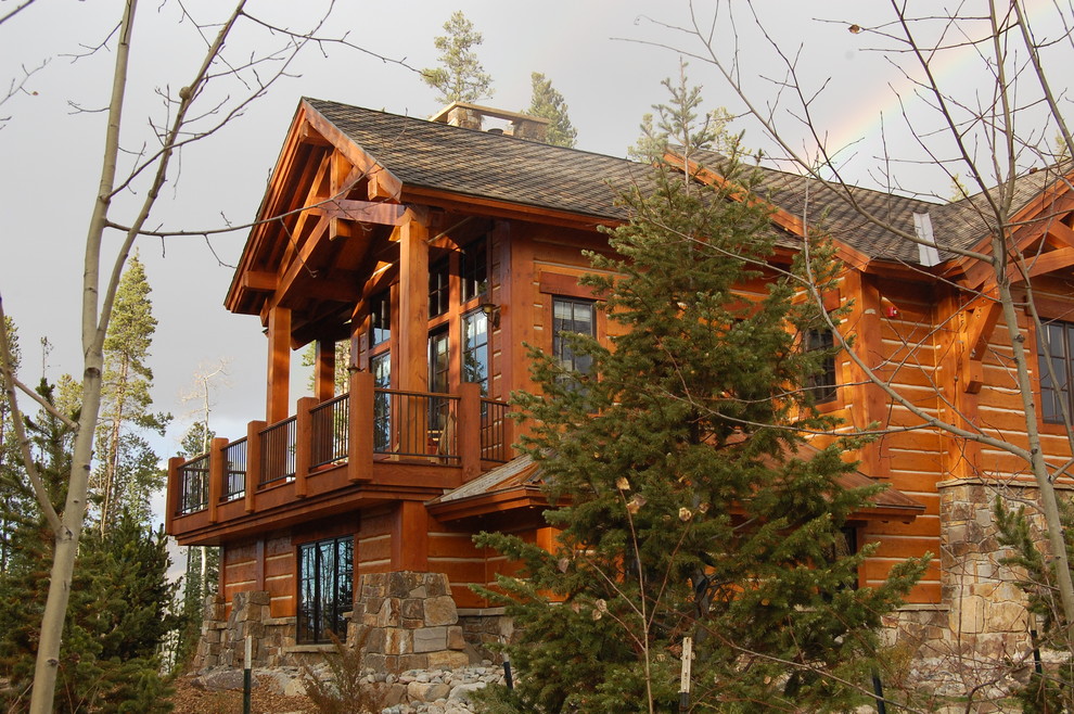 Inspiration for a rustic house exterior in Denver with wood cladding.