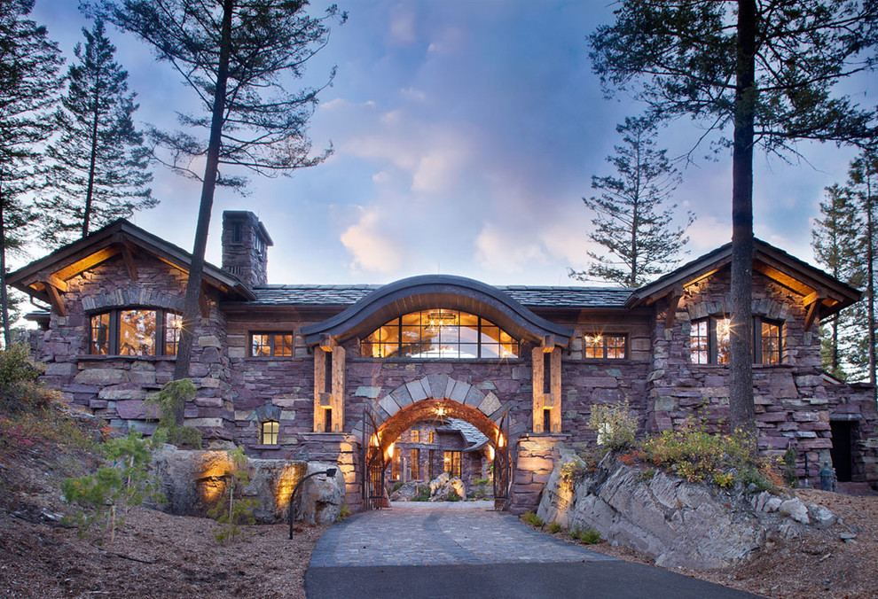 Inspiration for a large rustic brown stone exterior home remodel in Other