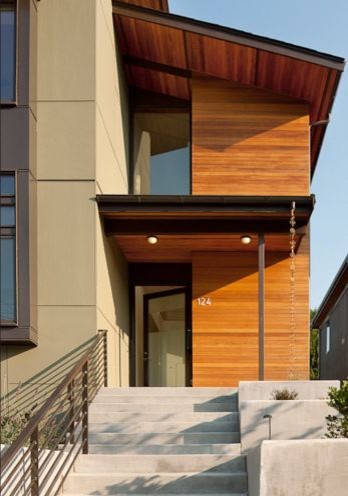 Réalisation d'une façade de maison verte minimaliste de taille moyenne et à un étage.
