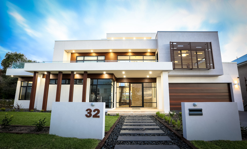Photo of an expansive and white contemporary render detached house in Sydney with three floors and a flat roof.