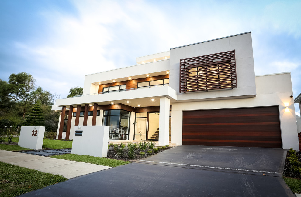 Expansive and white contemporary render detached house in Sydney with three floors and a flat roof.
