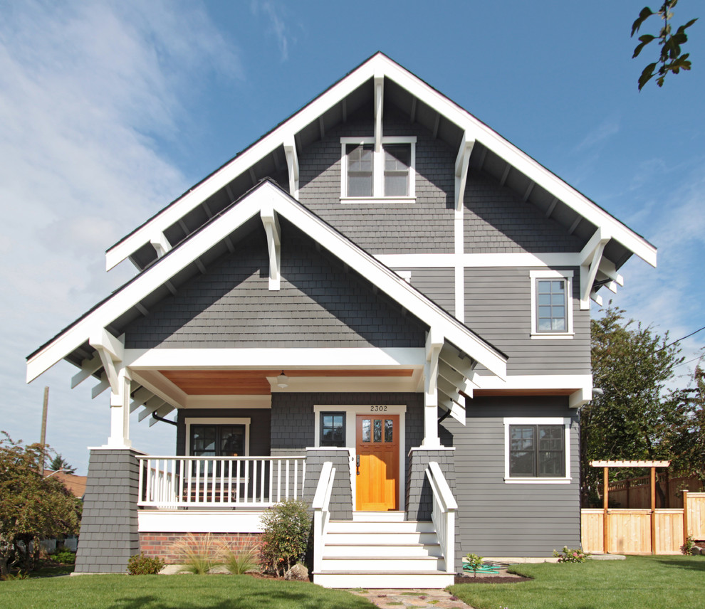 Example of a large arts and crafts gray three-story wood exterior home design in Seattle with a shingle roof