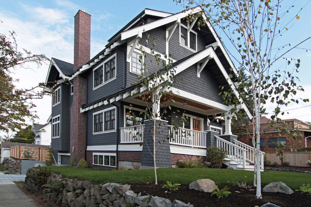 Large arts and crafts gray three-story wood exterior home photo in Seattle with a shingle roof
