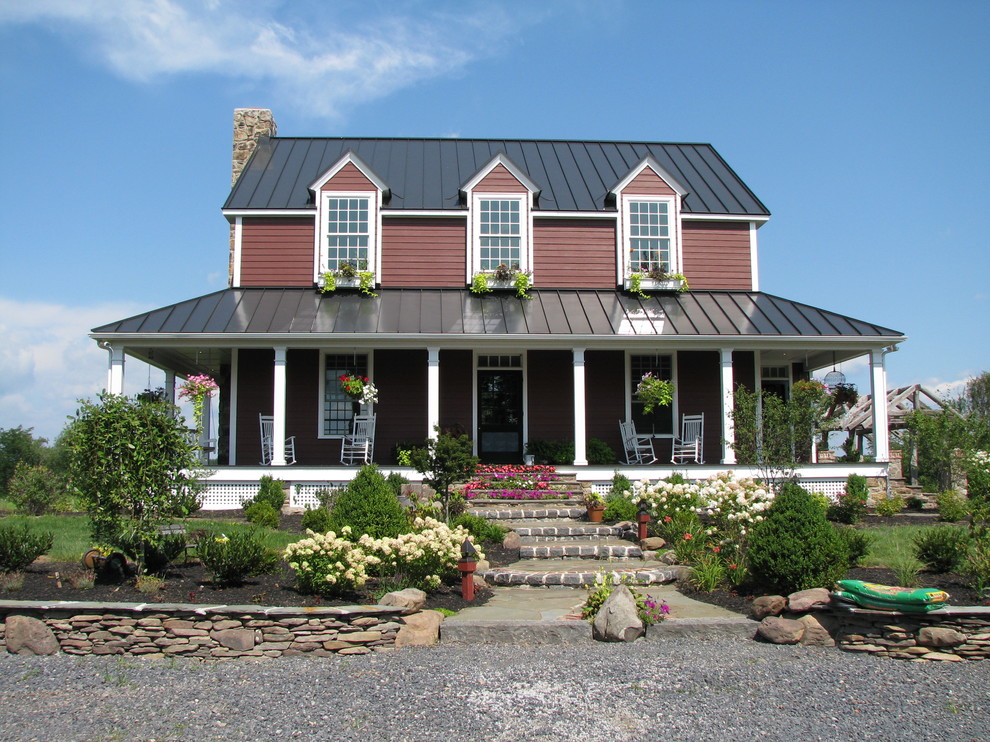 This is an example of a red rural two floor house exterior in Baltimore.