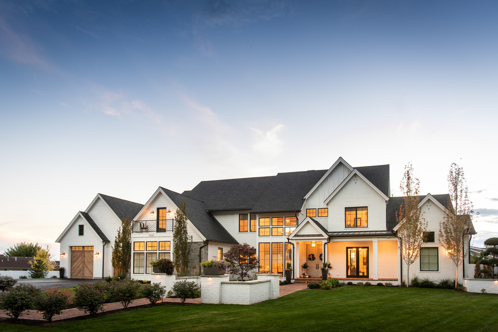 Inspiration for a farmhouse white two-story exterior home remodel in Salt Lake City with a shingle roof
