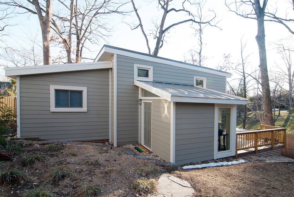 Inspiration for a small timeless gray one-story concrete fiberboard house exterior remodel in DC Metro with a shed roof and a metal roof
