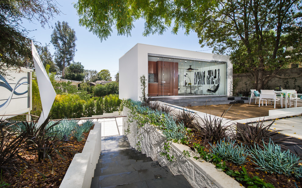Design ideas for a small and white contemporary bungalow render house exterior in Los Angeles with a flat roof.