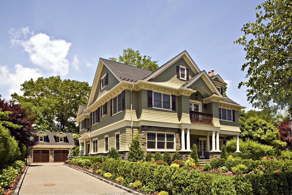 This is an example of a large victorian house exterior in New York with three floors and wood cladding.