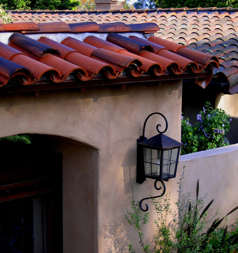 Mid-sized tuscan beige one-story stucco exterior home photo in Santa Barbara with a tile roof