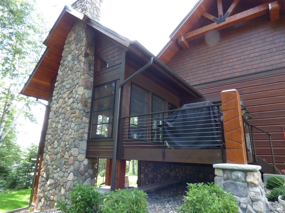 Example of a mid-sized mountain style brown two-story wood exterior home design in Other