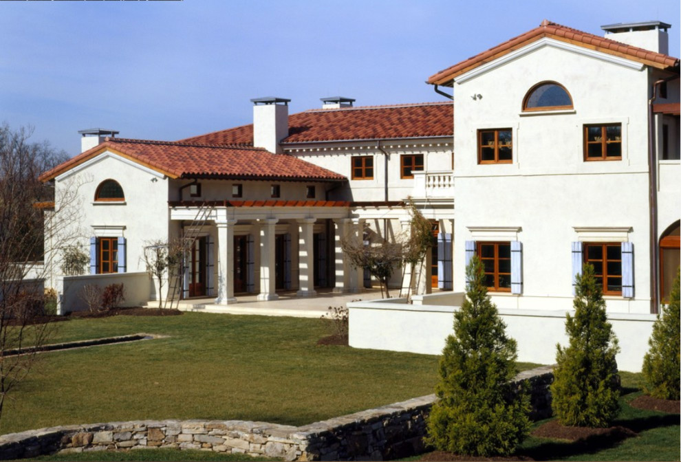 Large mediterranean white two-story stucco house exterior idea with a hip roof and a tile roof