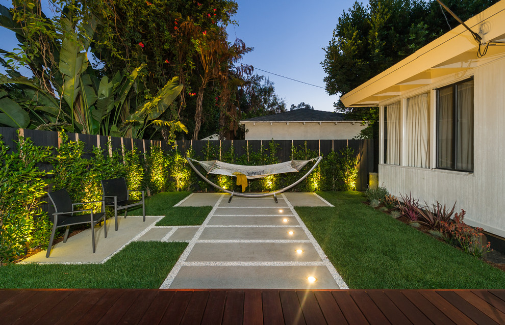 This is an example of a small and white contemporary bungalow house exterior in Los Angeles with wood cladding and a flat roof.