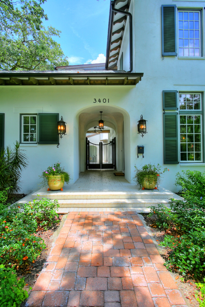 This is an example of a white world-inspired two floor render house exterior in Tampa.