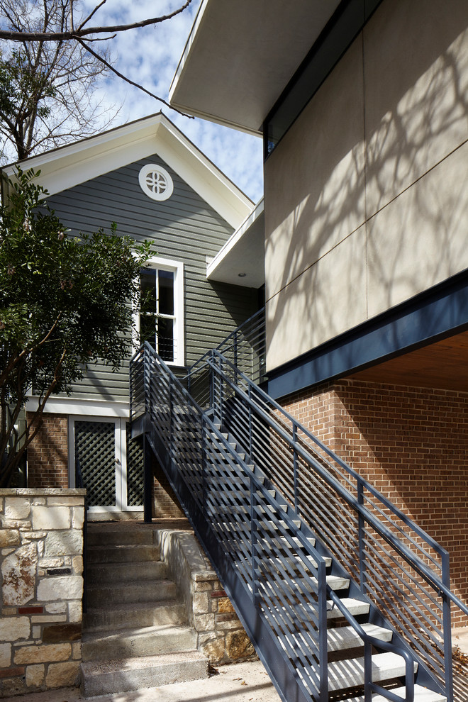 Example of a mid-sized minimalist beige two-story mixed siding exterior home design in Austin