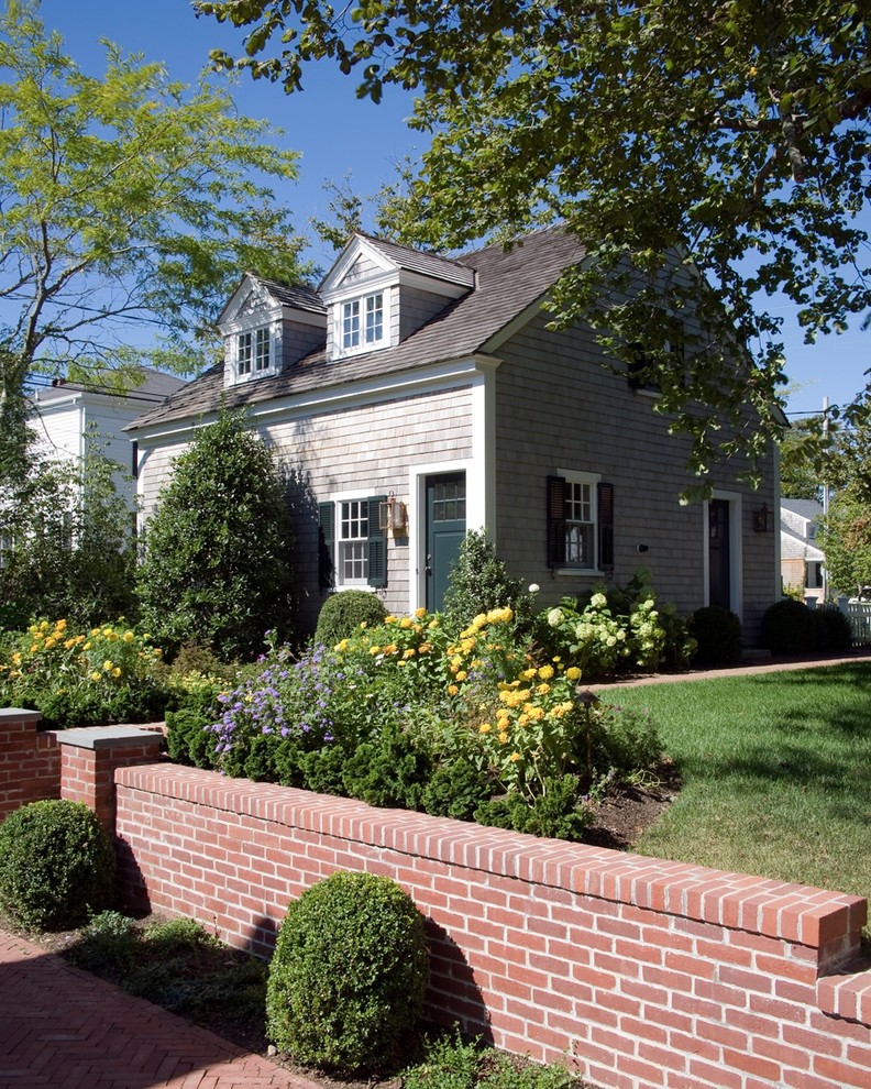 Inspiration for a small beach style two floor house exterior in Boston with wood cladding.