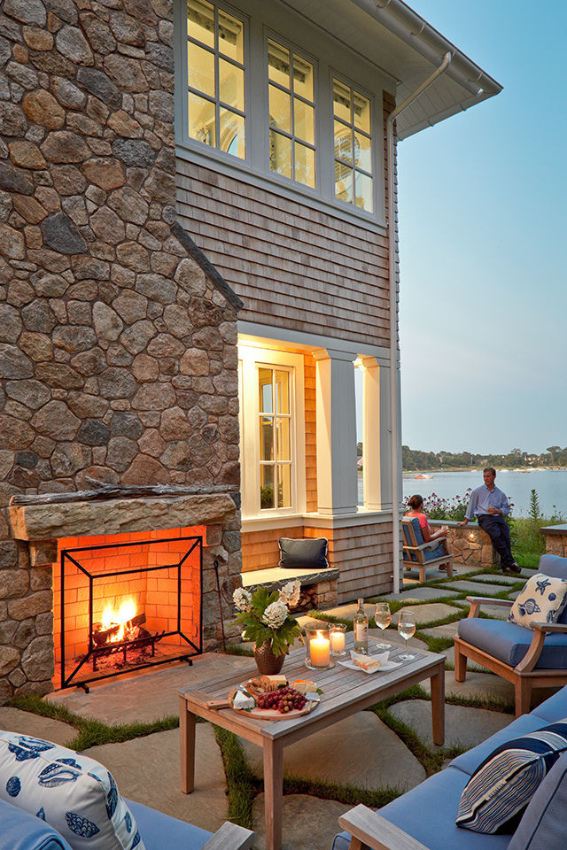 Example of a beach style wood house exterior design in Boston with a shingle roof