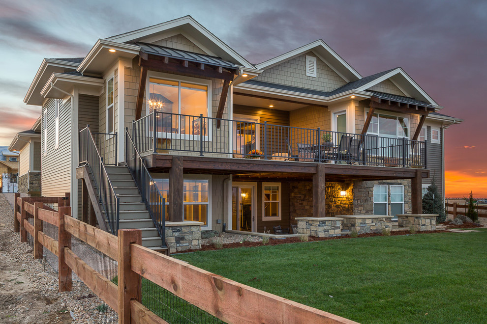 Example of a large transitional brown two-story mixed siding exterior home design in Denver with a hip roof