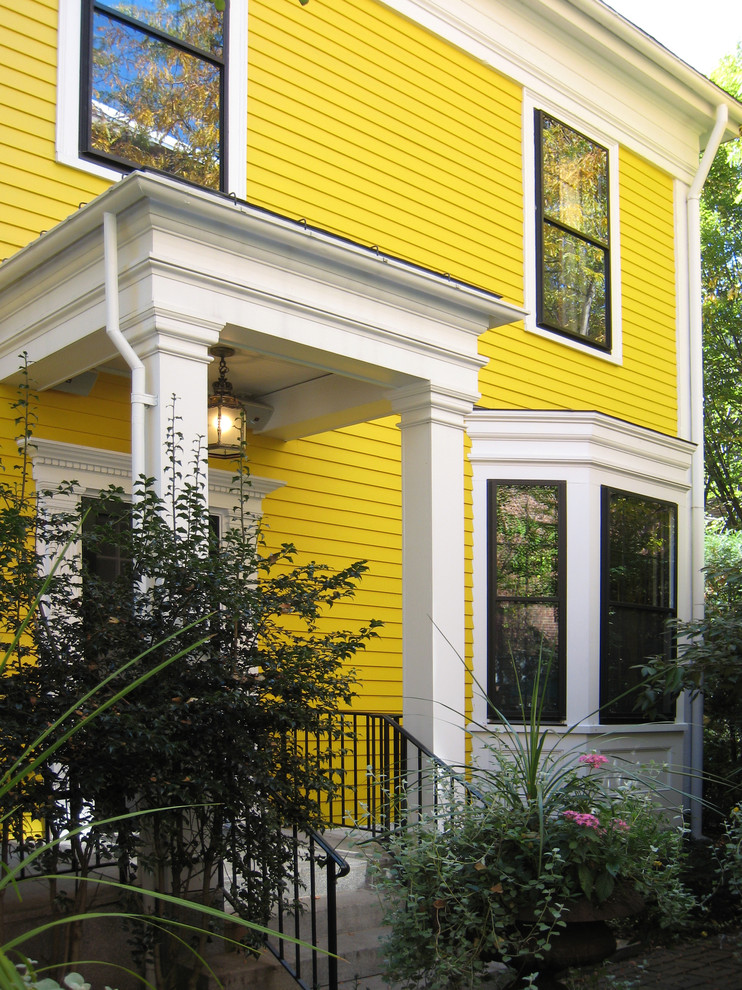 Mid-sized traditional yellow two-story wood exterior home idea in Boston