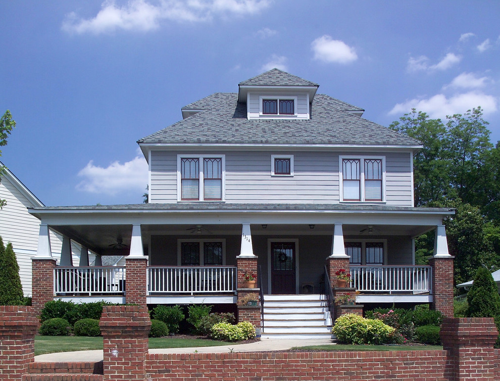 Example of a mid-sized arts and crafts gray three-story concrete fiberboard house exterior design in Atlanta with a hip roof and a shingle roof