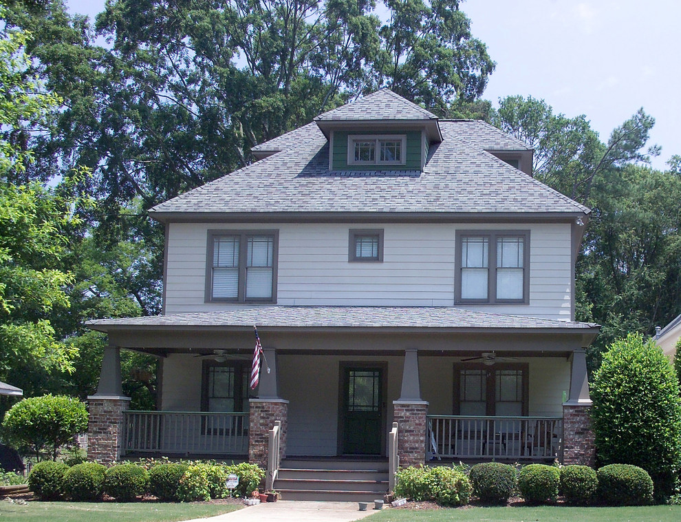 This is an example of a medium sized and gey traditional two floor detached house in Atlanta with concrete fibreboard cladding, a hip roof and a shingle roof.