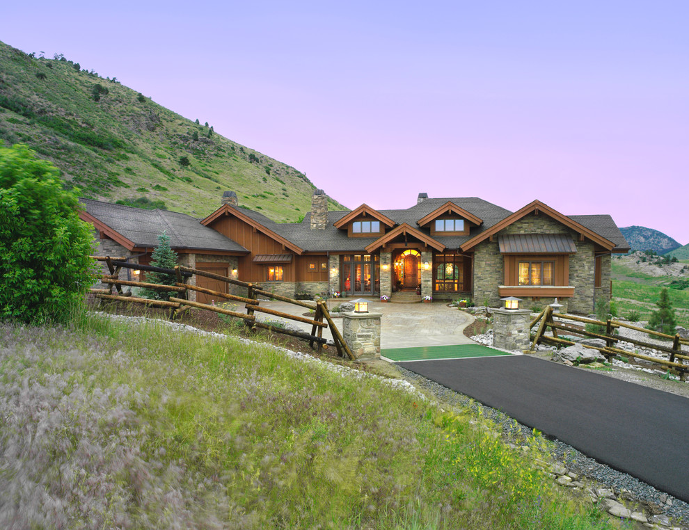 Example of a mountain style stone exterior home design in Denver