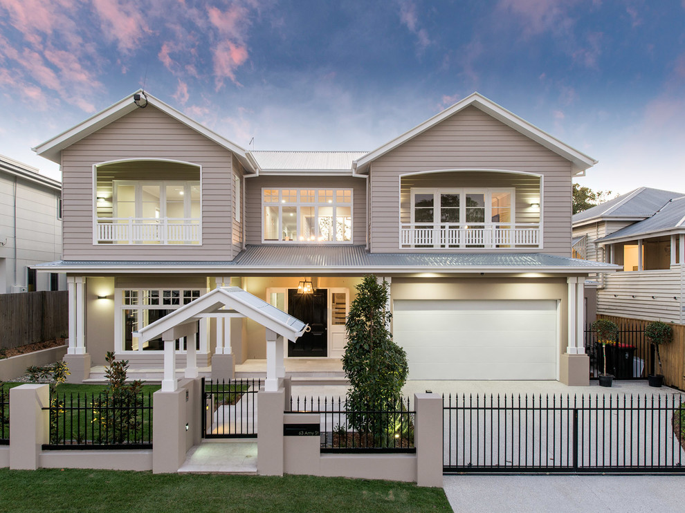 This is an example of a large and beige classic two floor detached house in Brisbane with a hip roof and a metal roof.