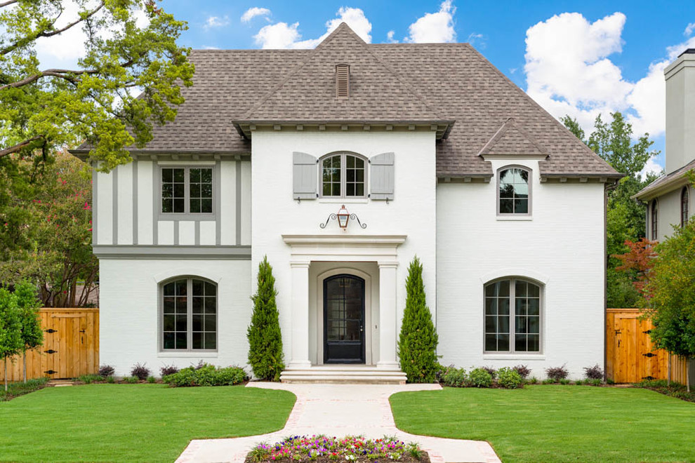 Traditional white two-story exterior home idea in Dallas with a hip roof and a shingle roof