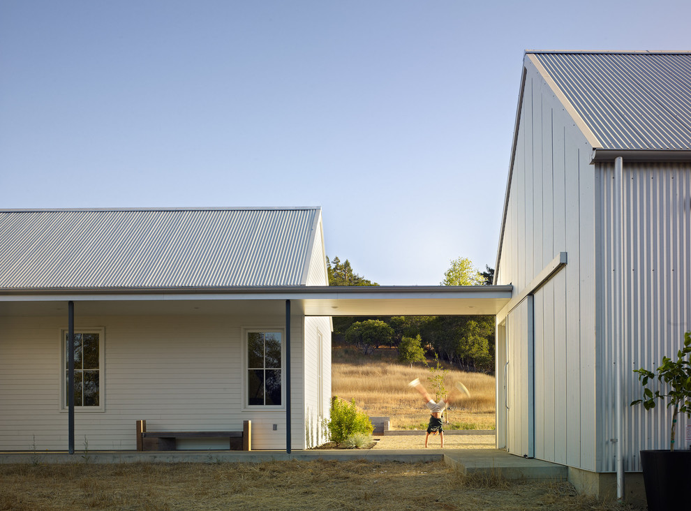 This is an example of a farmhouse house exterior in San Francisco with wood cladding.