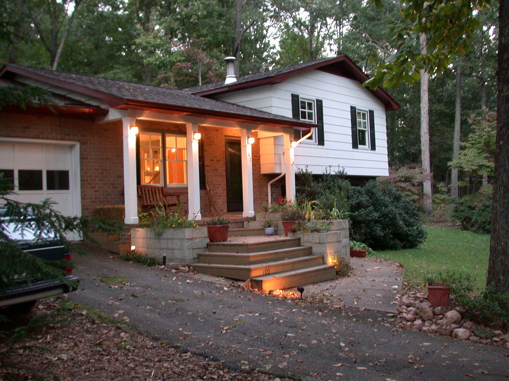 Example of a small eclectic white split-level concrete fiberboard exterior home design in Other