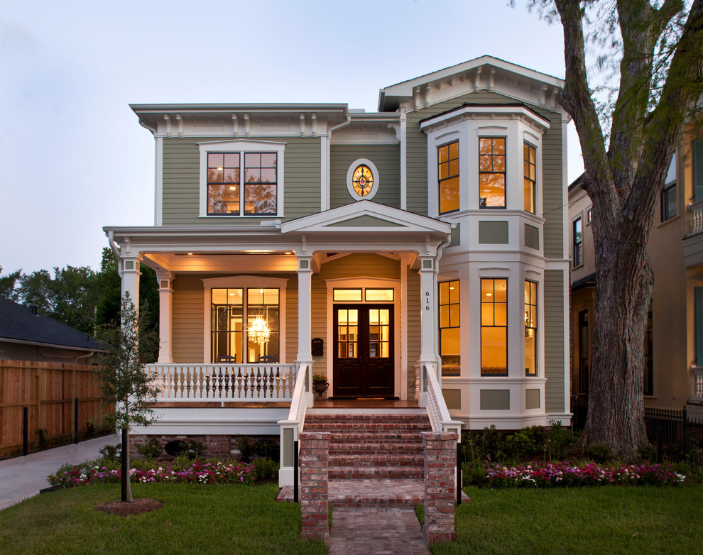 Green victorian two floor house exterior in Houston.