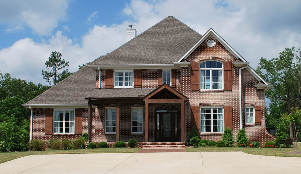 Inspiration for a large transitional two-story brick exterior home remodel in Birmingham with a shingle roof
