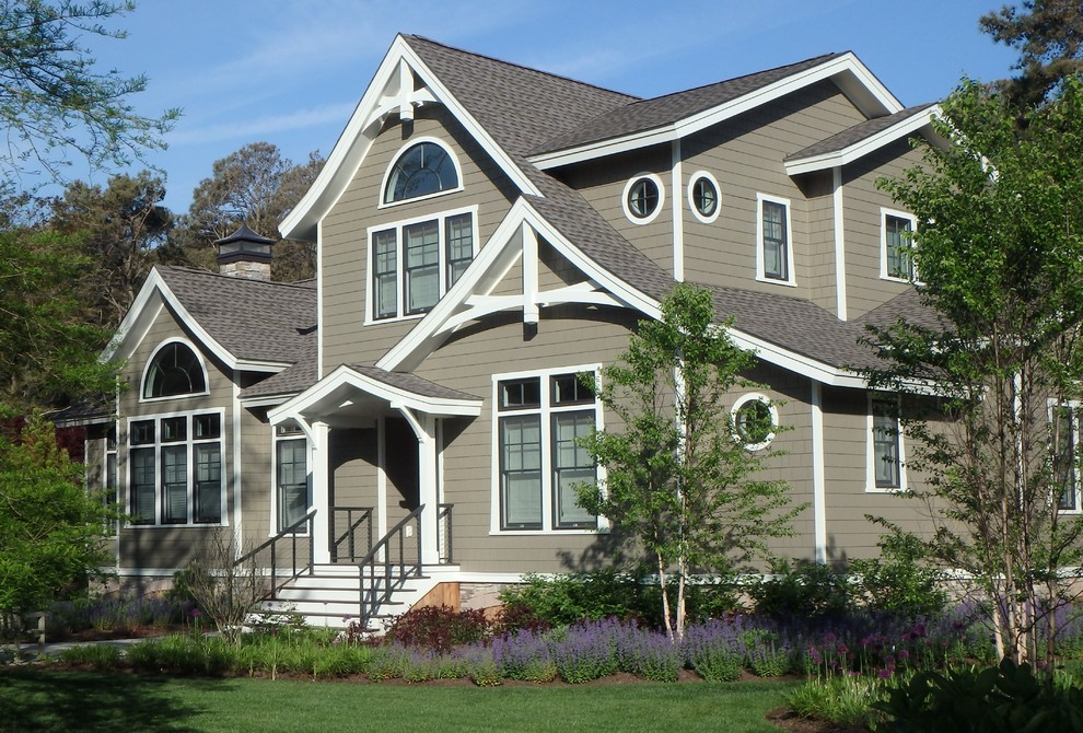 Inspiration for a large asian gray two-story wood gable roof remodel in Other
