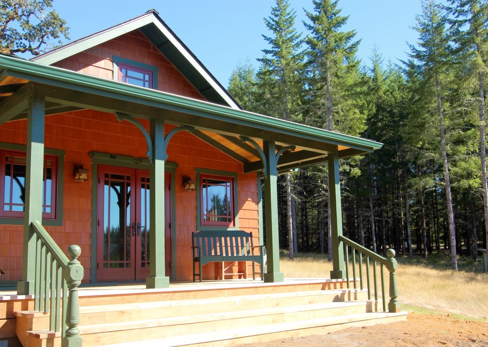 Example of a small arts and crafts one-story wood house exterior design in Other with a shingle roof
