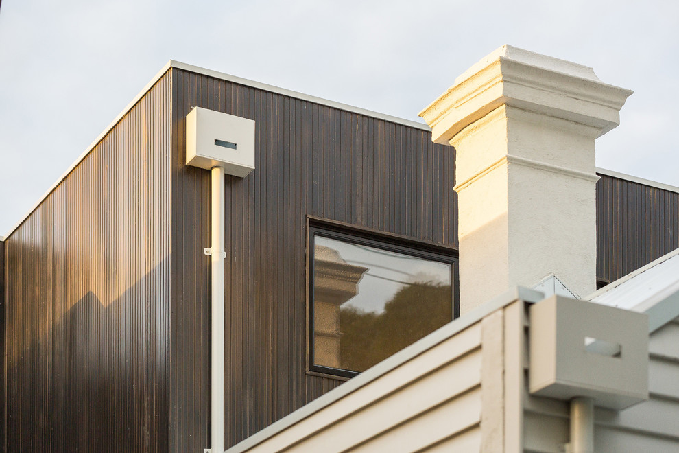 Mittelgroßes, Zweistöckiges Modernes Haus mit Flachdach und Blechdach in Melbourne